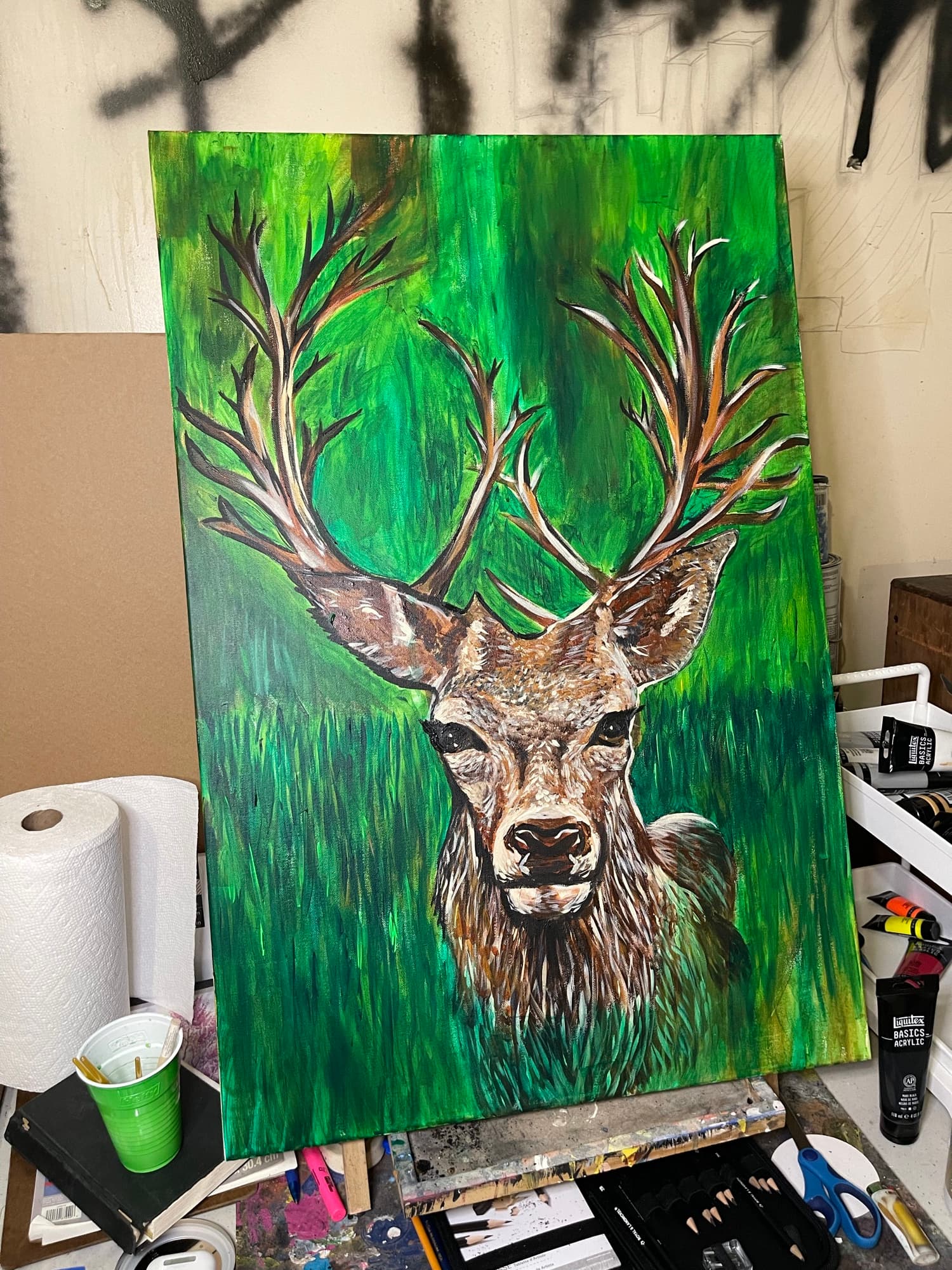 Deer portrait in progress on the easel.