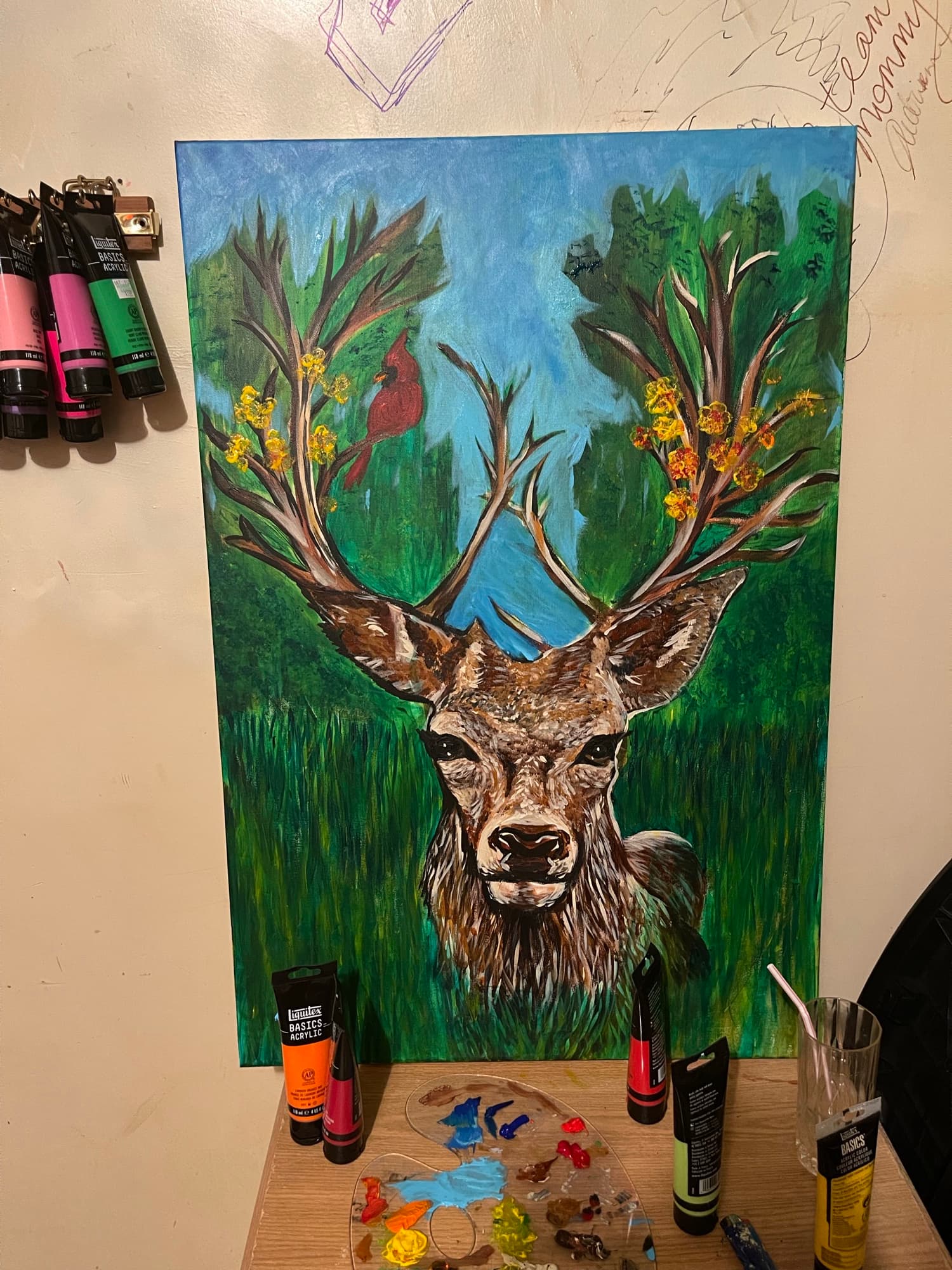 Deer Adorned with cardinal and flowers on the antlers.