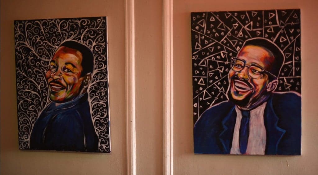 MLK and Malcolm X portrait pair hung on the wall - colorful civil-rights portraiture.