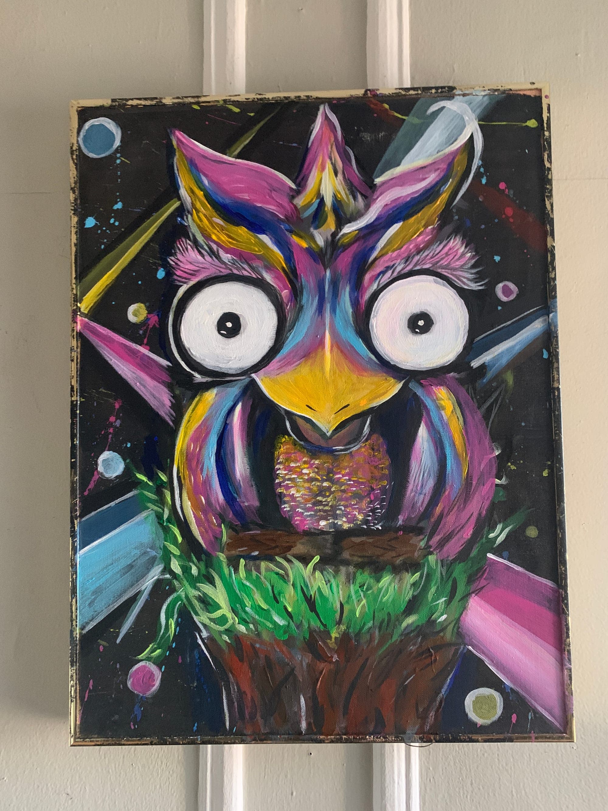 Owl painting framed and hung in a room setting.