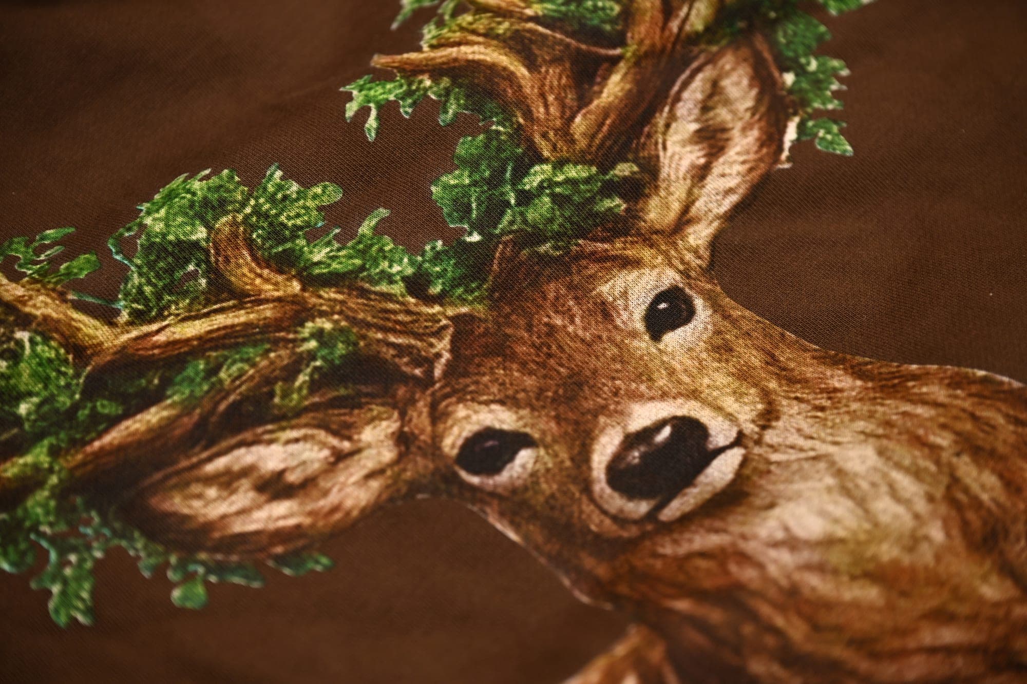 Deer painting artwork printed on Kamo King apparel, flat lay hero shot.