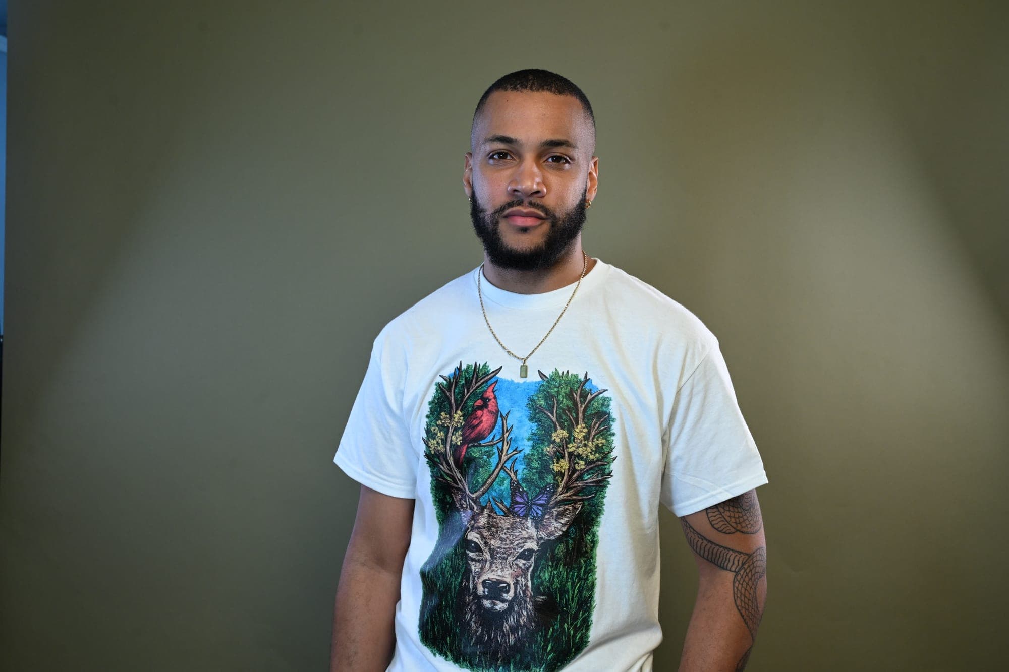 Studio portrait wearing the deer-painting tee.